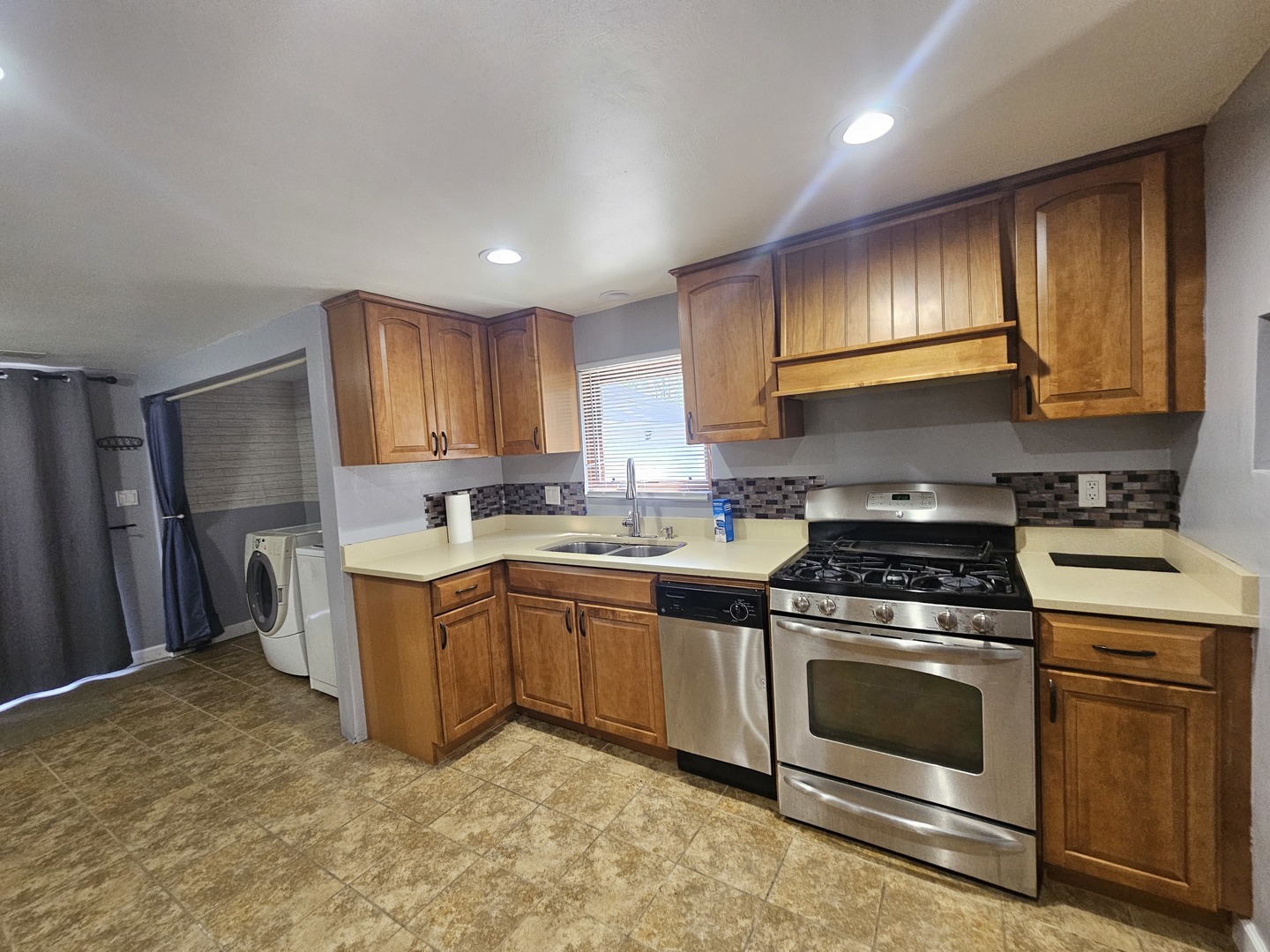 10N827 Hawthorne Street Elgin, IL 60123 - Photo 2 of 14 a kitchen with stainless steel appliances granite countertop a stove a sink and a refrigerator