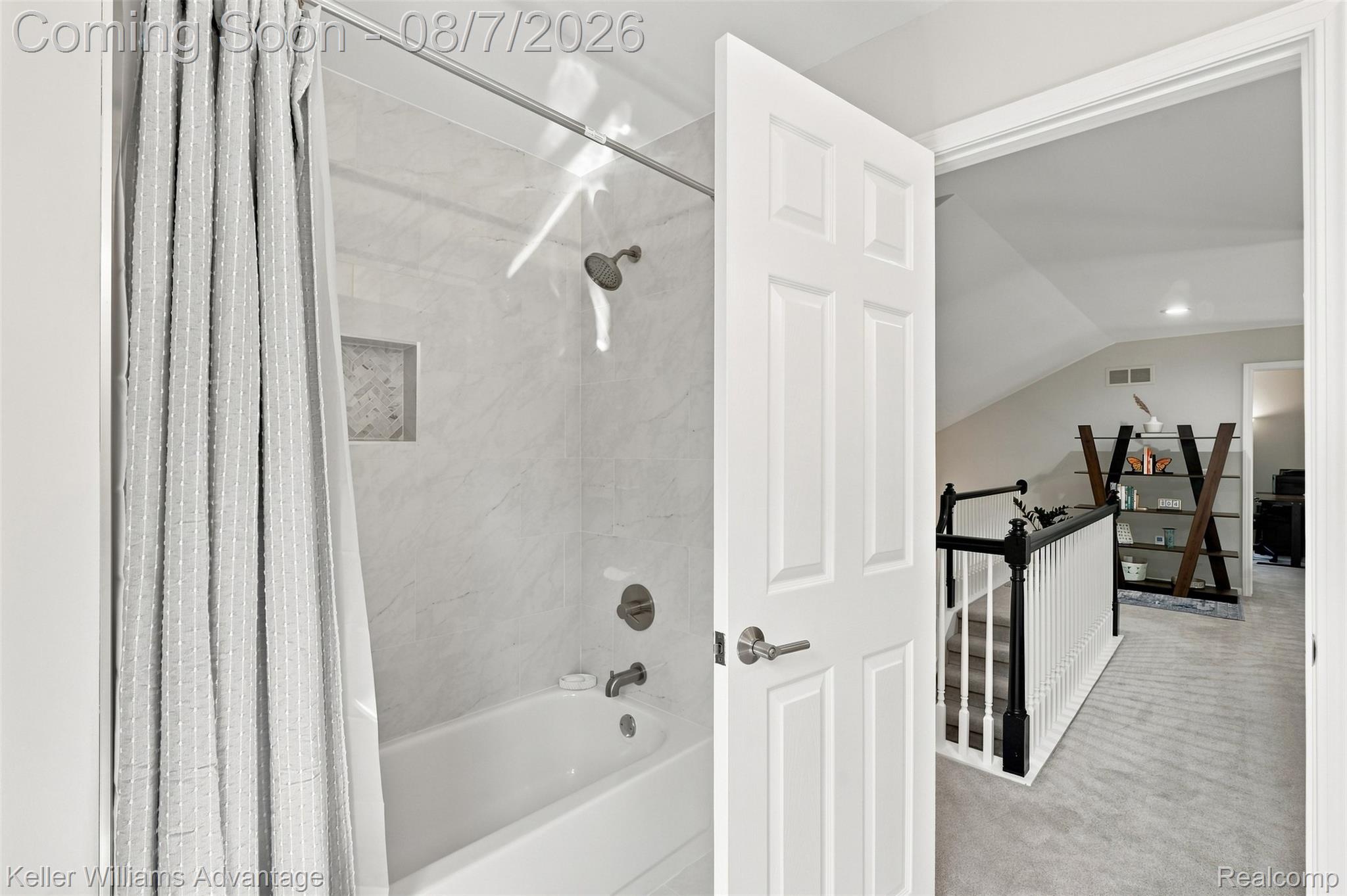 5325 Simpson Lake Road West Bloomfield, MI 48323 - Photo 23 of 43 Bathtub with tile surround, built-in shower niche, and brushed nickel fixtures