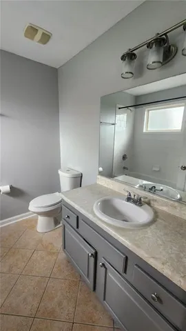 a bathroom with a sink toilet and a mirror