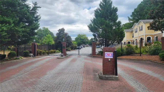 a sign board with buildings in the background