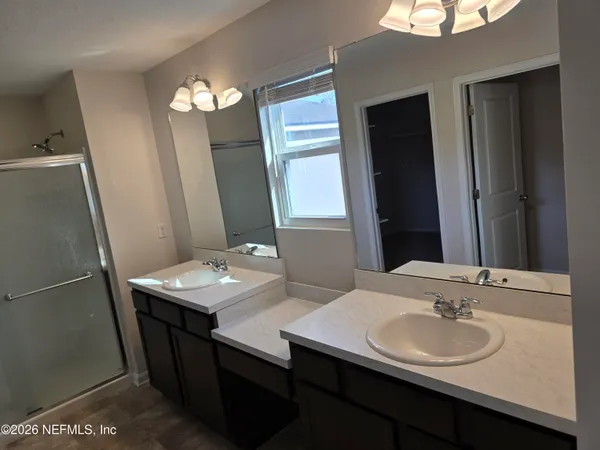 a bathroom with a glass shower door