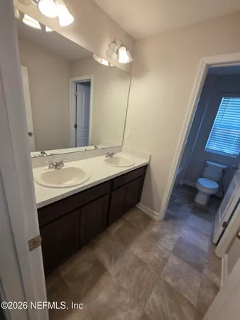 a white toilet sitting next to a bath tub