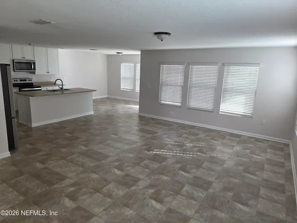 a view of a kitchen with a sink cabinets and a window