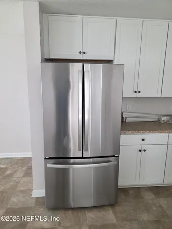 a white refrigerator freezer sitting in a kitchen