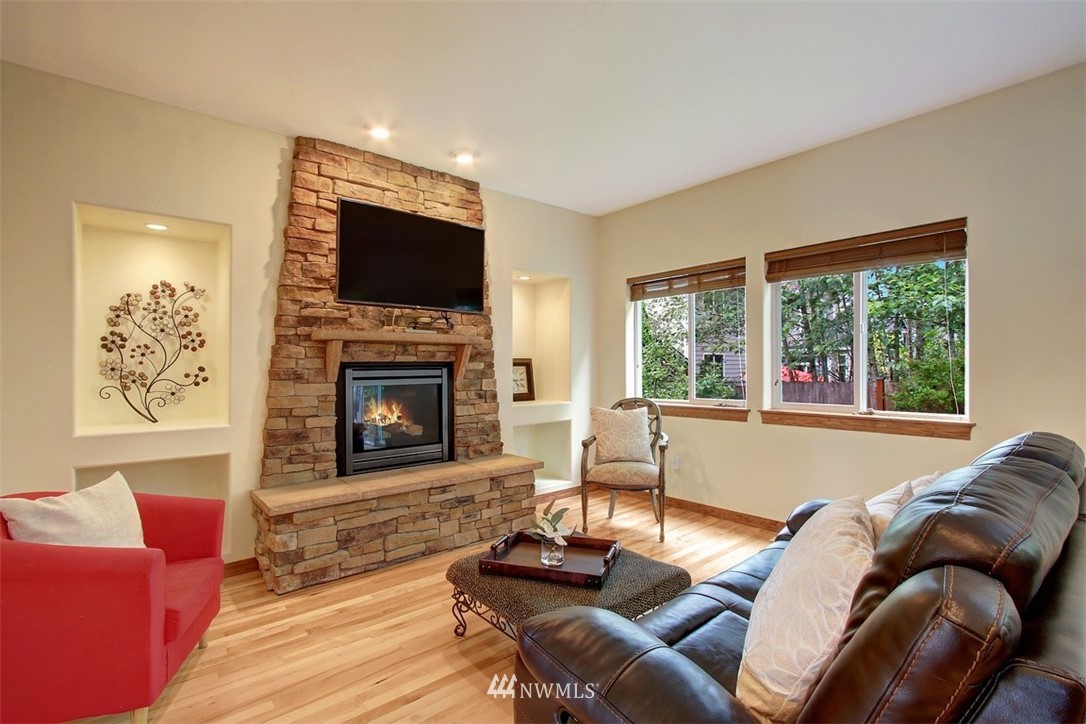 3221 172 Street Southeast Bothell, WA 98012 - Photo 3 of 23 a living room with furniture fireplace and a flat screen tv