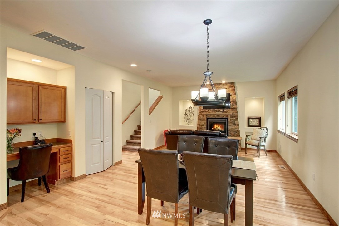 3221 172 Street Southeast Bothell, WA 98012 - Photo 8 of 23 a dining room with furniture a chandelier and wooden floor