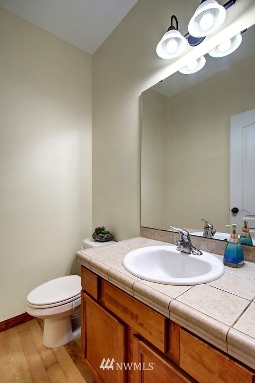3221 172 Street Southeast Bothell, WA 98012 - Photo 9 of 23 a bathroom with a sink a toilet and a mirror