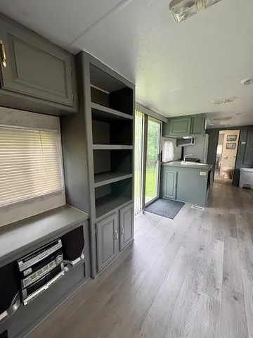 a bed sitting in a bedroom next to a window