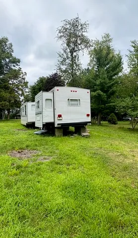 a view of a house with a yard and sitting area
