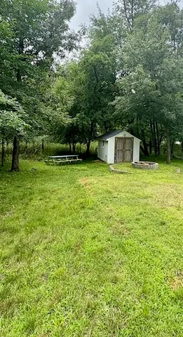 a view of a pool with a small yard