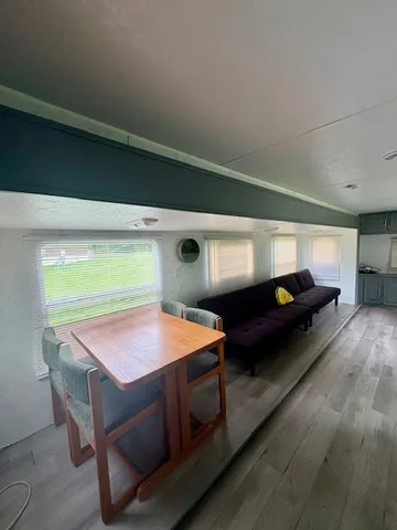 a kitchen with granite countertop a refrigerator a stove a microwave and wooden floor