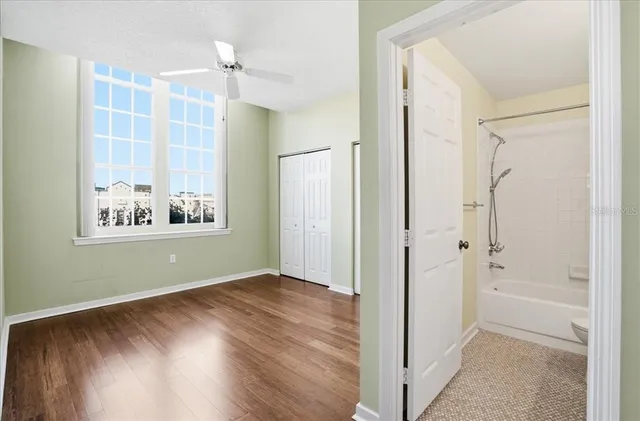 a view of a bathroom with wooden floor and a window