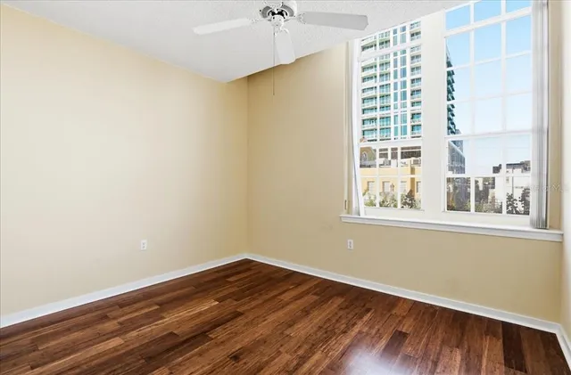 a view of a room with wooden floor and a window