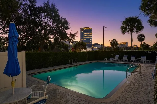 a view of a swimming pool with a table and chairs
