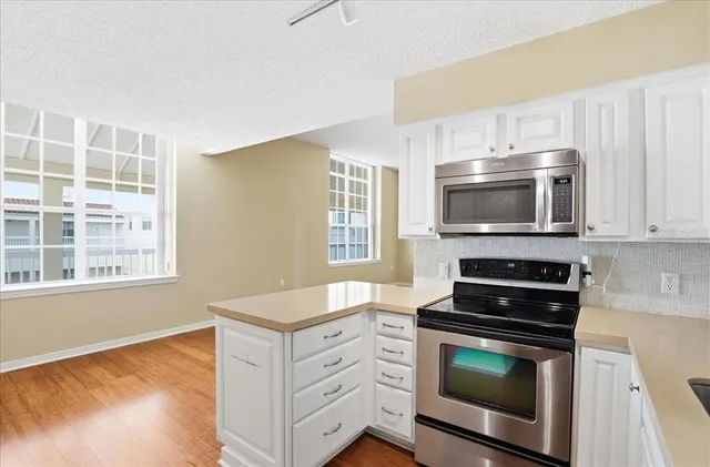 a kitchen with granite countertop a stove and a microwave oven