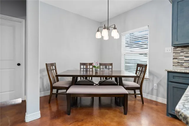 a view of a dining room with furniture wooden floor and chandelier