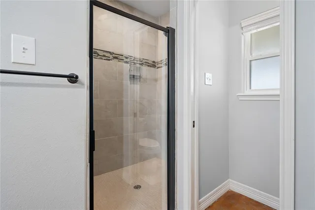 a bathroom with a glass shower door
