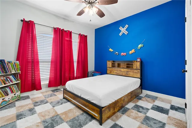 a bedroom with a large bed and a bookshelf