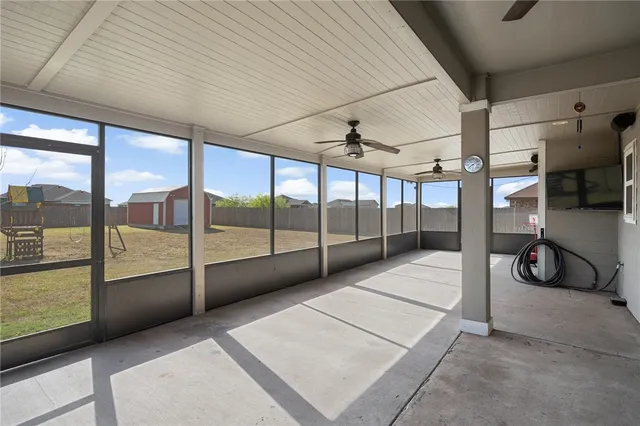 a view of an empty room with glass door