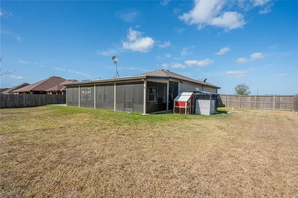 a swimming pool with outdoor seating and yard
