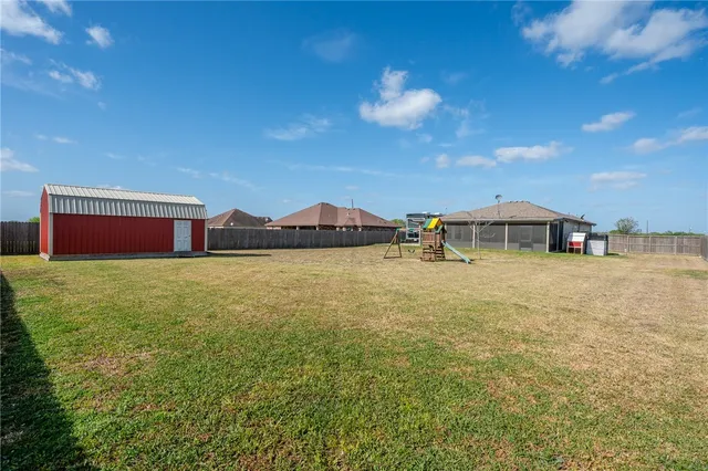 a backyard of a house with table and chairs