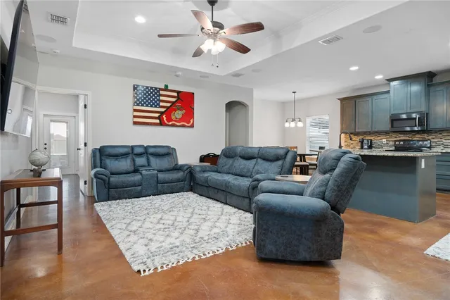 a living room with furniture kitchen and a table