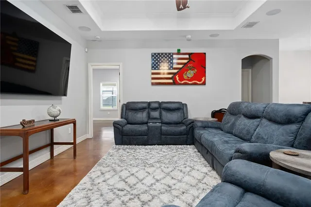 a living room with furniture and a flat screen tv