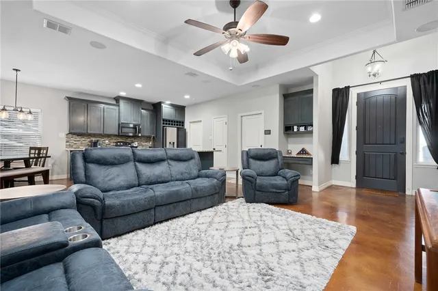 a living room with furniture and a chandelier