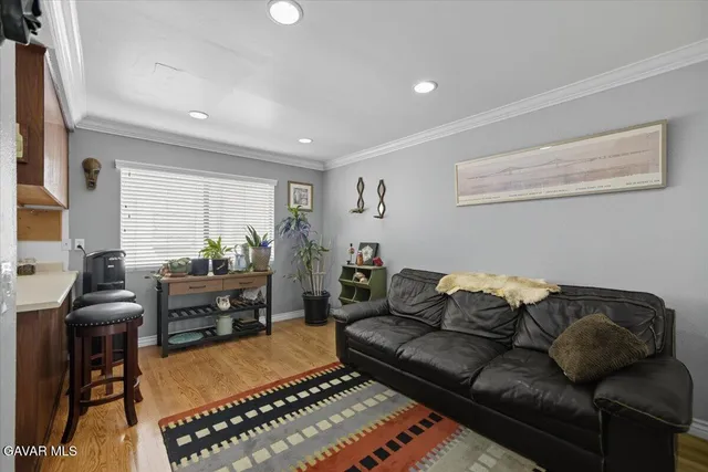 a living room with furniture a rug and a window