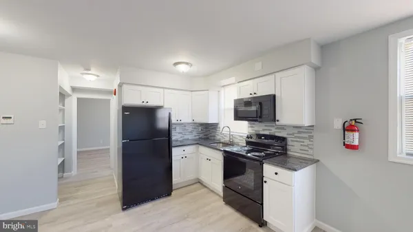 a kitchen with stainless steel appliances granite countertop a refrigerator stove and microwave