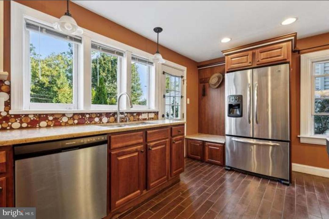 617 Manchester Avenue Media, PA 19063 - Photo 3 of 17 a kitchen with stainless steel appliances granite countertop a refrigerator and wooden cabinets