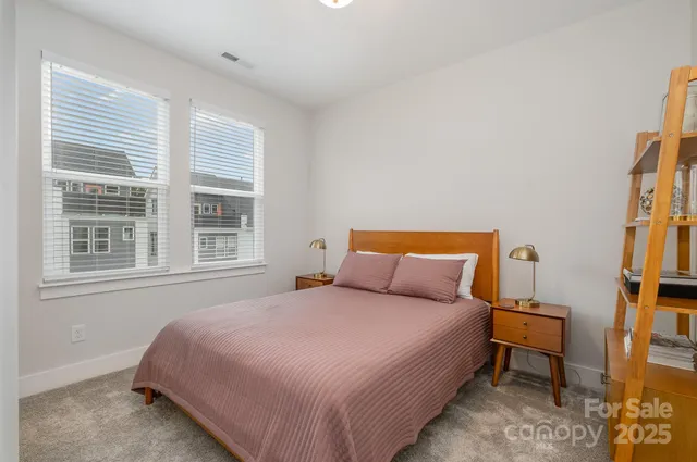 a bedroom with a bed wooden floor and a window