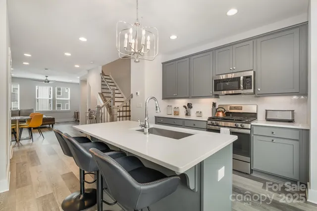 a kitchen with a stove a sink and a refrigerator