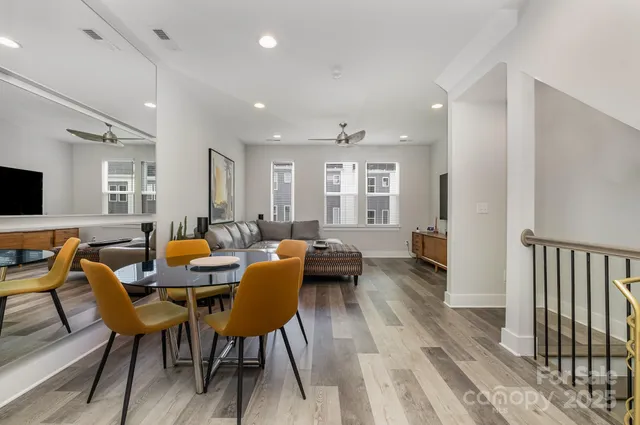 a living room with furniture a wooden floor and a flat screen tv