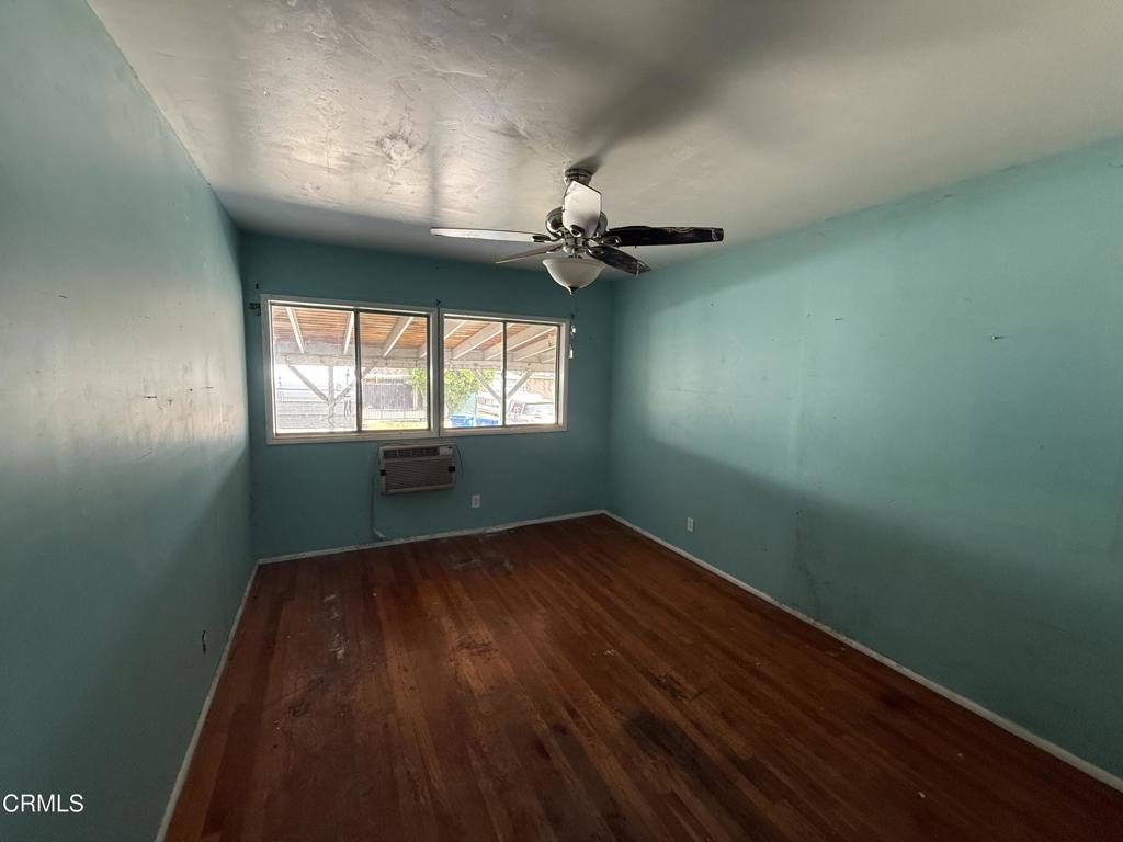14306 Aztec Street Sylmar, CA 91342 - Photo 14 of 21 an empty room with wooden floor fan and windows