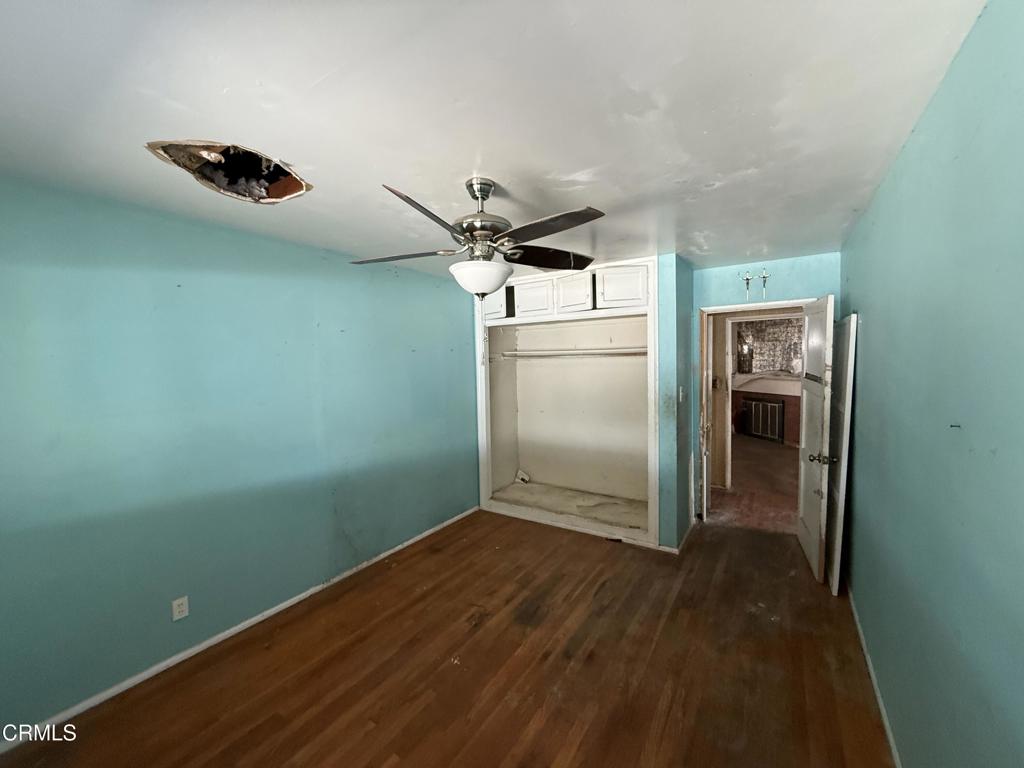 14306 Aztec Street Sylmar, CA 91342 - Photo 15 of 21 an empty room with wooden floor cabinet and windows