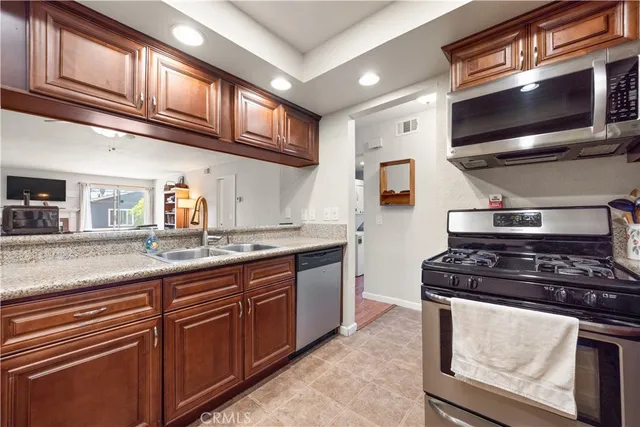 a spacious bedroom with a bed a mirror and a window