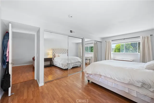 a spacious bathroom with a double vanity sink toilet and a mirror