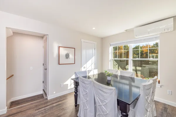a view of a dining room with furniture large window and wooden floor