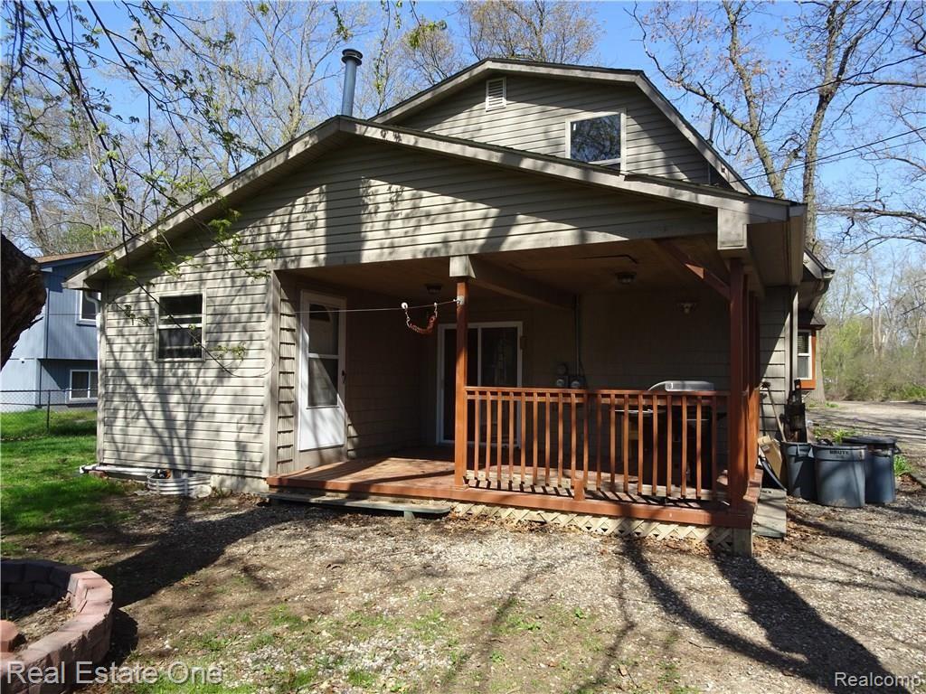 4895 Eagle Road Highland, MI 48356 - Photo 15 of 16 Doorwall leading to covered porch, great for morning cup of coffee or family barbeque!