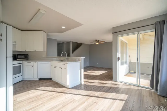 a view of a kitchen with electric appliances
