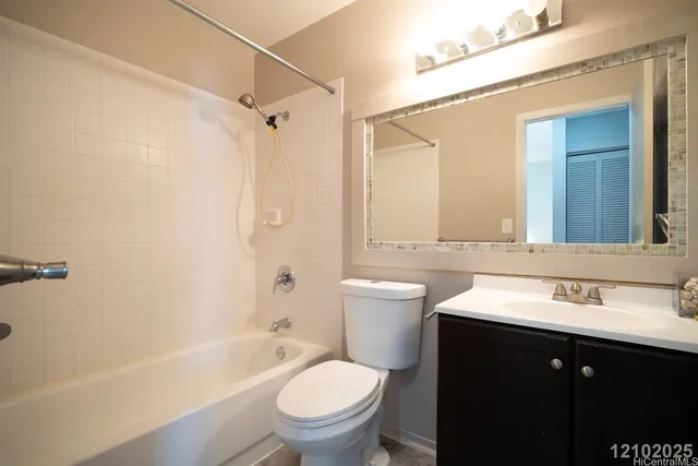 a bathroom with a sink a toilet a mirror a bathtub and shower