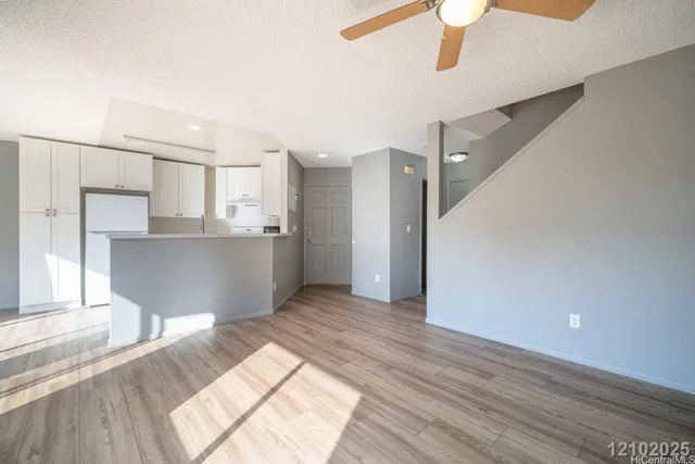 a view of a kitchen with wooden floor and a kitchen