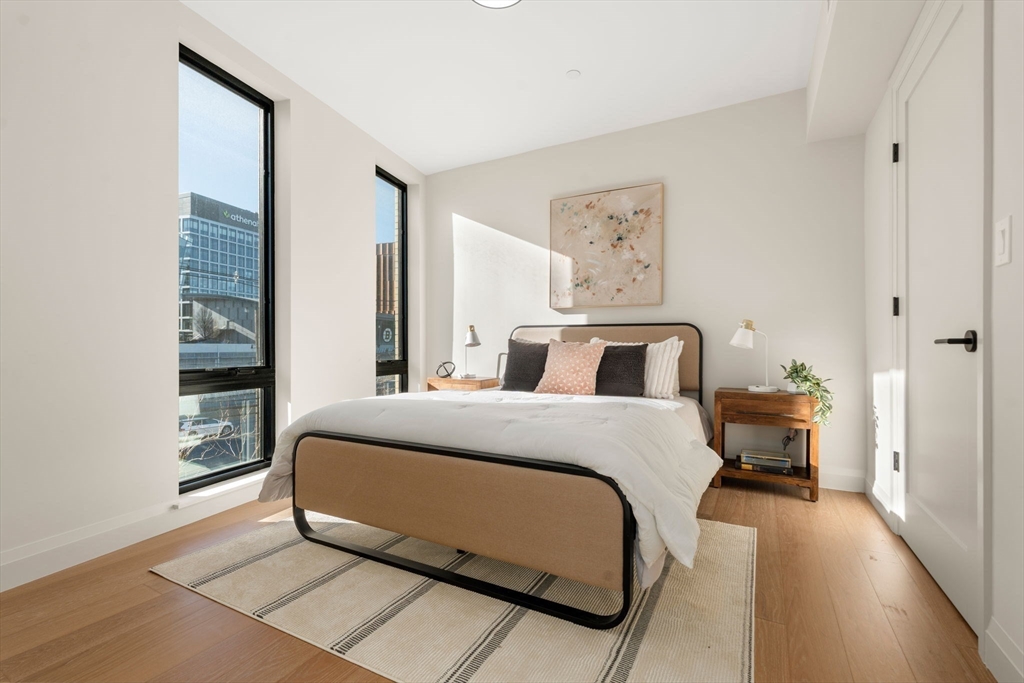 a bedroom with a large bed and paintings on the wall