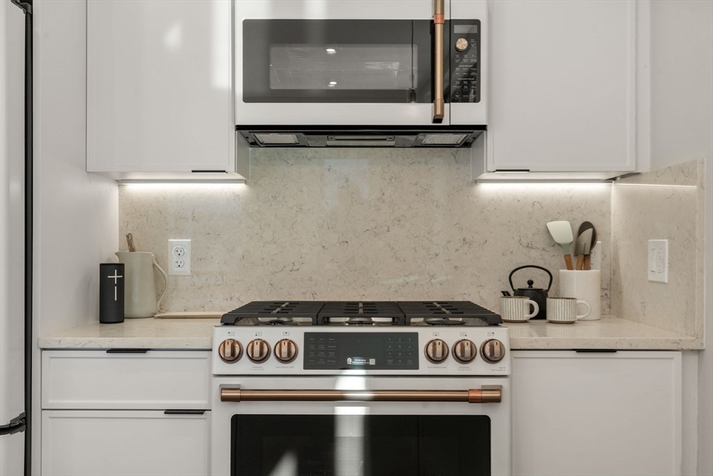 100 Lincoln Street, Unit 403 Boston, MA 02135 - Photo 14 of 23 a stove top oven sitting inside of a kitchen