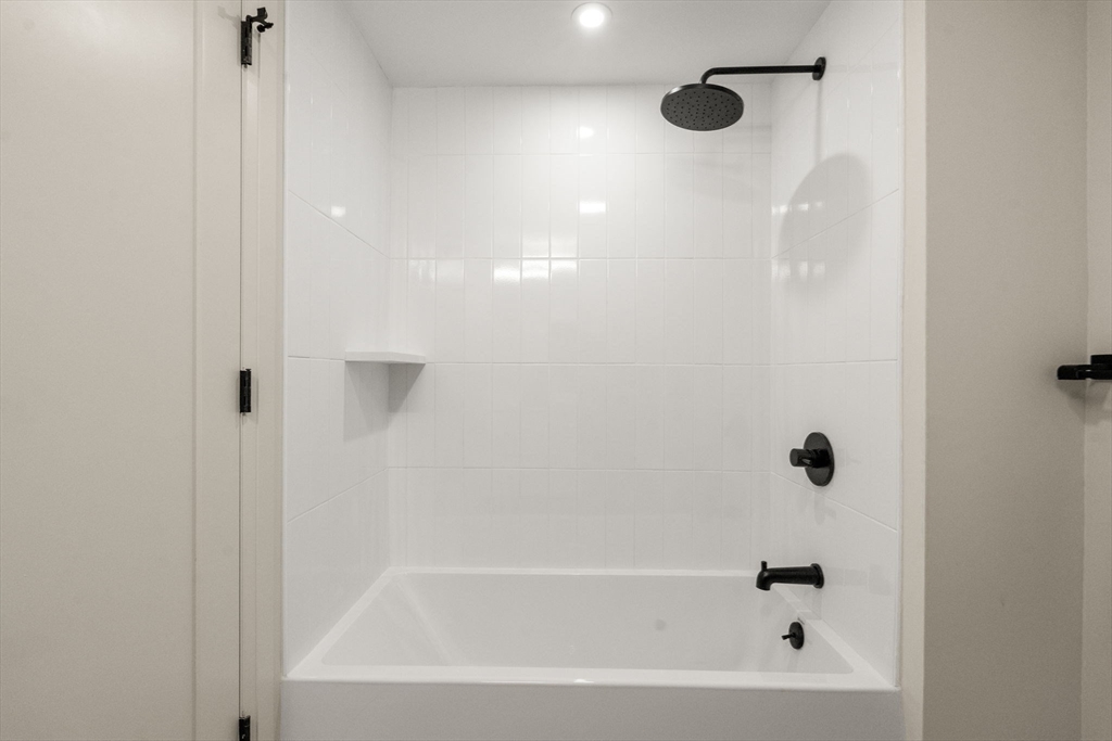 100 Lincoln Street, Unit 403 Boston, MA 02135 - Photo 7 of 23 a close up of a bathtub curtain