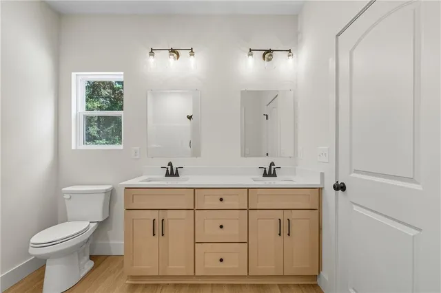 a bathroom with a sink a toilet and a mirror