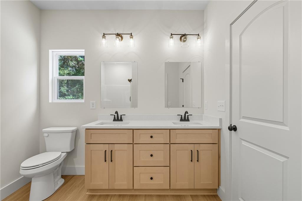 193 Tabitha Page Lane Toccoa, GA 30577 - Photo 13 of 33 a bathroom with a sink a toilet and a mirror