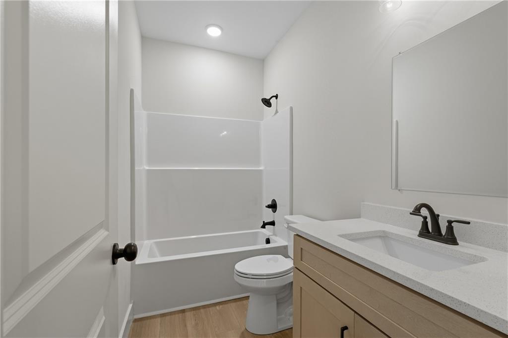 193 Tabitha Page Lane Toccoa, GA 30577 - Photo 18 of 33 a bathroom with a granite countertop sink a toilet and shower