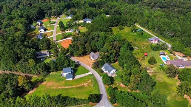 an aerial view of a house with swimming pool and garden